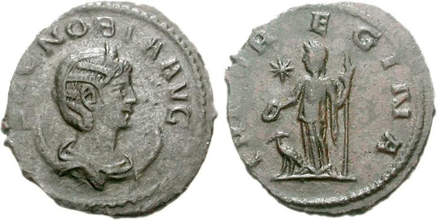 A picture of two silver coins is shown on a white background. The coins are round and jagged along the edge, with some details rubbed off. The coin on the left shows the profile of a woman looking to the right wearing a headdress with round circular objects around her neck. The letters “ZENOBIAAVG” can be seen going around the other edge of the coin, with the “Z” and the “E” cut off and very faded. The coin on the right shows the outline of a woman in thin flowing robes standing with an object in her right hand and a staff in the left hand. An animal is at her feet and an eight-pointed star is to her right. The words “REGINA” can be seen on the perimeter of the coin with some other letters faded and unreadable.