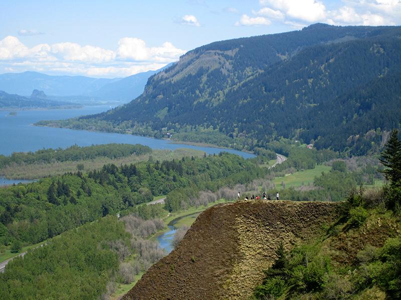 Aerial view of amountainous area with a river winding through it.