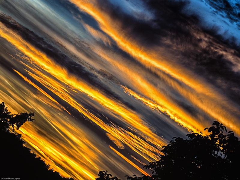 Sky at sunrise, with low clouds glowing brightly with reflected light.