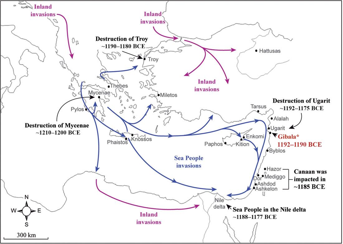 A map is shown. Black lines are drawn all over. A compass is located in the bottom left corner as well as a scale indicating “300 km.” In the northwest corner of the map a dark pink arrowed line in heading south and labelled “Inland invasions.” Another dark pink arrowed line is shown in the north of the map heading southeast and then splitting into three – one heading east toward a black dot labelled Hattusas, one heading south, and one heading southwest. The last dark pink arrow is seen across the bottom of the map heading from west to east to an area labelled “Nile delta.” A small black arrow points to the “Nile delta” and is labelled “Sea People in the Nile Delta ~ 1188-1177 BCE.” Blue arrowed lines show in the middle of the map and are labelled “Sea people invasions.” The first arrow begins in an area in the middle west of the map by a city labelled Thebes. The arrow heads north a bit then heads northeast to a city labelled Troy. A black arrow points to the city of Troy and is labelled “Destruction of Troy ~ 1190-1180 BCE.” Another blue arrow begins west of Thebes and heads south past a city labelled Pylos and splits into three – one heading south and meeting up with a dark pink arrow across the bottom of the map, one heading north toward a city labelled Mycenae (a black arrow points to Mycenae and is labelled “Destruction of Mycenae ~ 1210-1200 BCE”), and one heading southeast to a city labelled Phaistos, continuing southeast to the Nile delta area. Another blue arrowed line begins just southeast of Mycenae and heads southeast splitting into three directions. The first heads northeast to a city labelled Miletos. The second heads southeast past the cities of Knossos and Phaistos continuing southeast toward the Nile delta. The third blue arrow heads straight east where it splits off into three directions. One head northeast. The second one heads east just south of the city of Tarsus, then just west of the cities of Alalah, Urgarit, Gibala (which is labelled in red with an “*” after the name and “1192-1190 BCE”), Byblos, Hazor, Mediggo, Dor, Ashdod, and Ashkelon, and ending right before the “Nile delta.” The third portion of this blue line heads southeast toward the city of Kition and Enkomi then joins with the second blue line of this path just south of Byblos. A black arrow points to the city of Ugarit and is labelled “Destruction of Ugarit ~ 1192-1175 BCE.” The cities of Hazor, Mediggo, Ashdod, and Ashkelon are indicated with a bracket with the label: “Canaan was impacted in ~1185 BCE.” To the west of the city of Kition the city of Paphos is labelled.