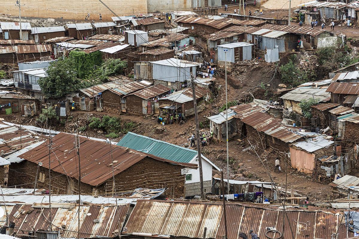 Dilapidated slum dwellings are shown from above.