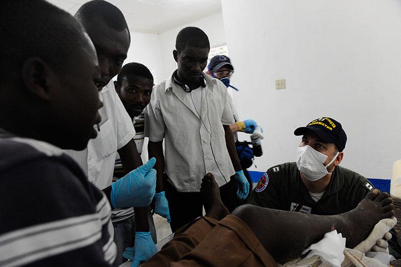 Health care workers treat an injured person.