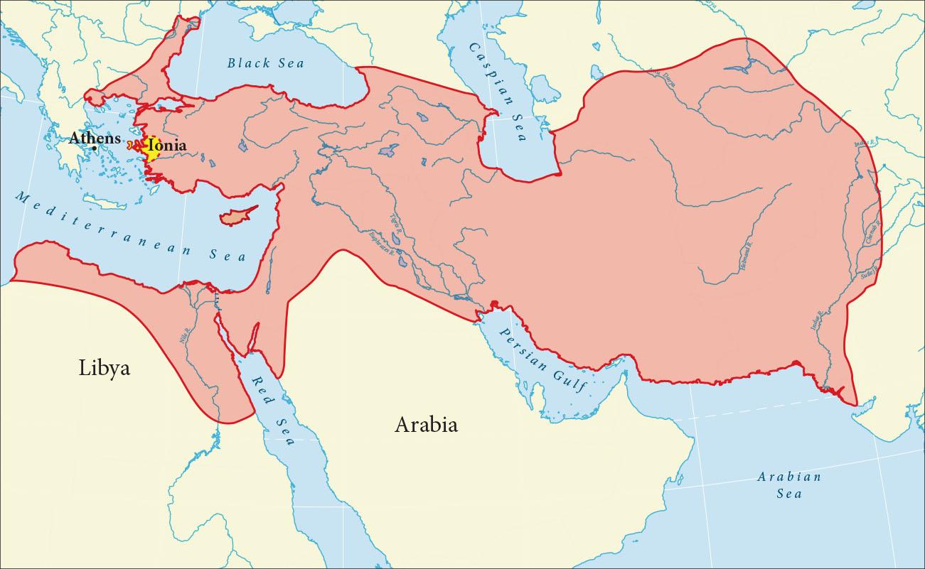 A map is shown with land highlighted beige and water highlighted blue. Blue lines run throughout the lands.  The Black Sea and the Caspian Sea are labelled in the north, the Mediterranean Sea is labelled in the west, and the Red Sea, the Persian Gulf and the Arabian Sea are labelled in the south. The Nile River and the Suez Canal are labelled at the southeast of the Mediterranean and the Tigris River. and the Euphrates River are labelled northwest of the Persian Gulf. The Amu Darya is labelled to the east of the Caspian Sea. The Indus River the Chenab River the Sudej River and the Helmand River are labelled in the east of the map. The country of Libya is labelled in the southwest of the map and the country of Arabia is labelled in the south middle of the map. A large area from the west of the Black Sea, down to the northern portion of Libya, east to the end of the map is highlighted pink. Athens is labeled outside of the highlighted portion in the west. A small eastern region inside the highlighted portion is highlighted yellow and labeled Ionia.