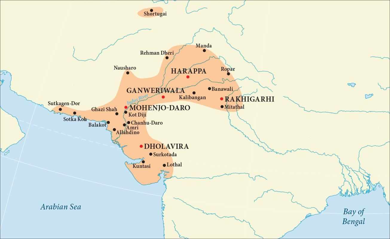 A map is shown with land in beige and water in blue. The Arabian Sea is labelled in the southwest and the Bay of Bengal is labelled in the southeast.  A “C” shaped area off the northeastern coast of the Arabian Sea is highlighted orange and the Indus River runs through the middle, from northeast to southwest. Areas labelled with red dots, from north to south, in this orange area are: Harappa, Ganweriwala, Rakhigarhi, Mohenjo-Daro, and Dholavira. Cities labelled with black dots in this orange area are, from north to south: Manda, Rehman Dheri, Nausharo, Ropar, Banawali, Kalibangan, Mitathal, Sutkagen-Dor, Sotka Koh, Ghazi Shah, Kot Diji, Balakot, Chanhu-Daro, Amri, Allahdino, Surkotada, Kuntasi, and Lothal. A small oval area in the far north is also highlighted orange with the city of Shortugai labelled with a black dot within.